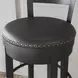 Valebeck Black Upholstered Swivel Counter Height Stool With Ladder Back
